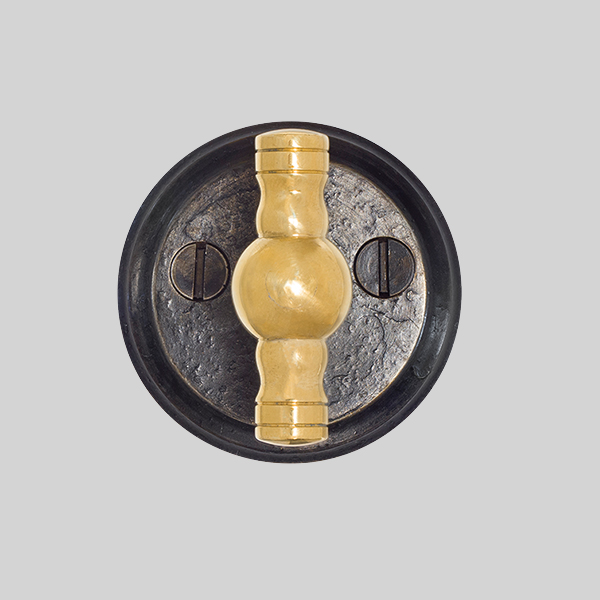 Shown with a dark wax iron and polished brass finish.